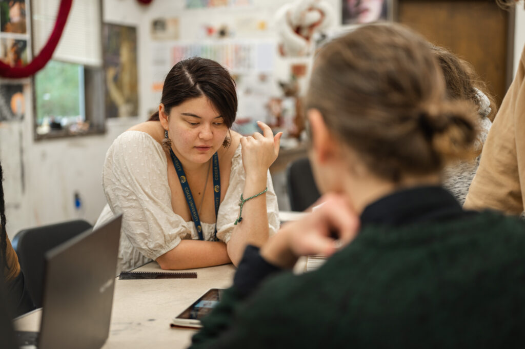 Two students work on assignments in class