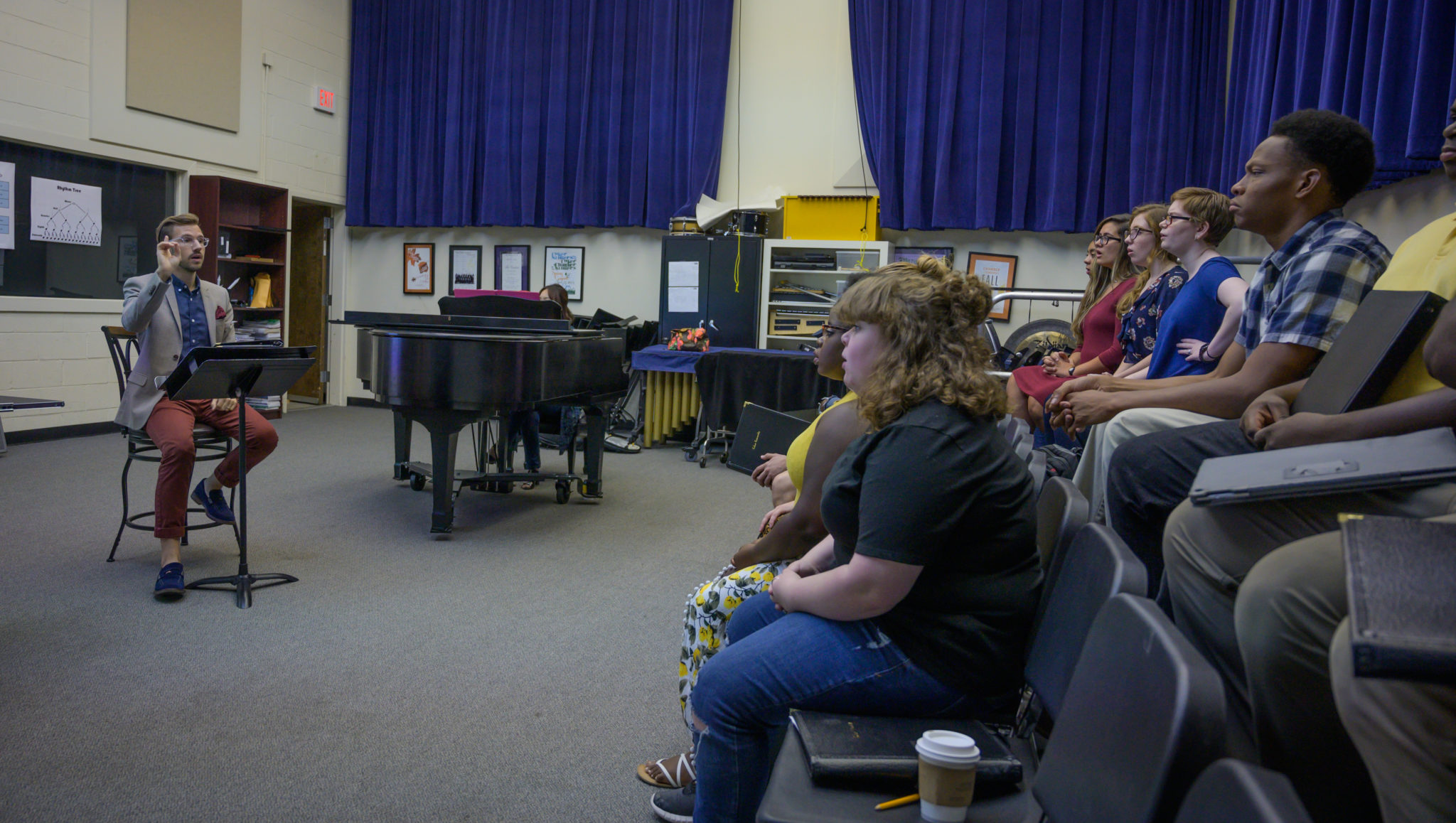 A professor instructing multiple students in a classroom
