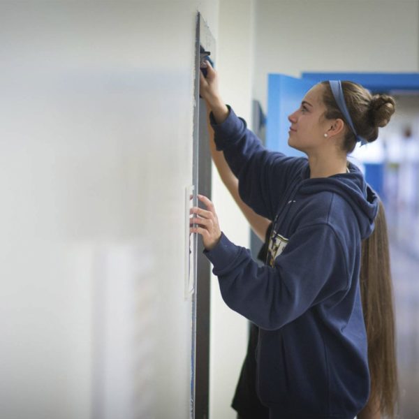 Students do community service, painting and patching up a wall at the Hartsville Y.