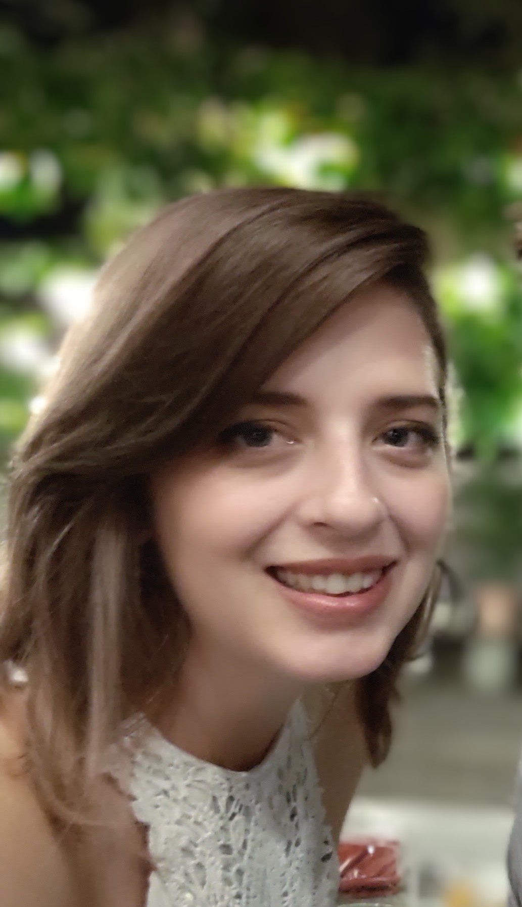 Ashlee Taylor, a brunette with brown eyes smiling at the camera