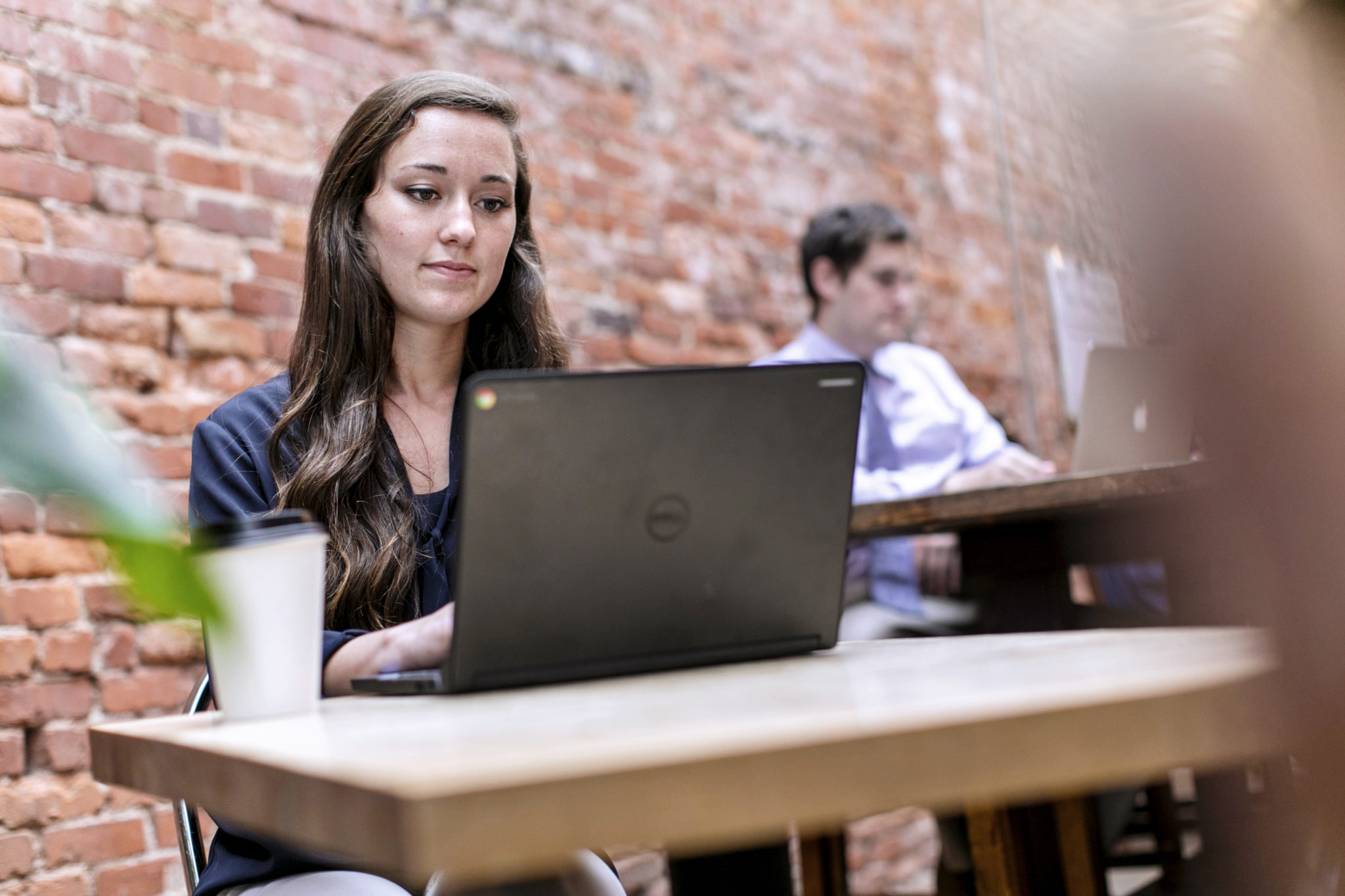 Coker student studying at a table in a restaurant (decorative)