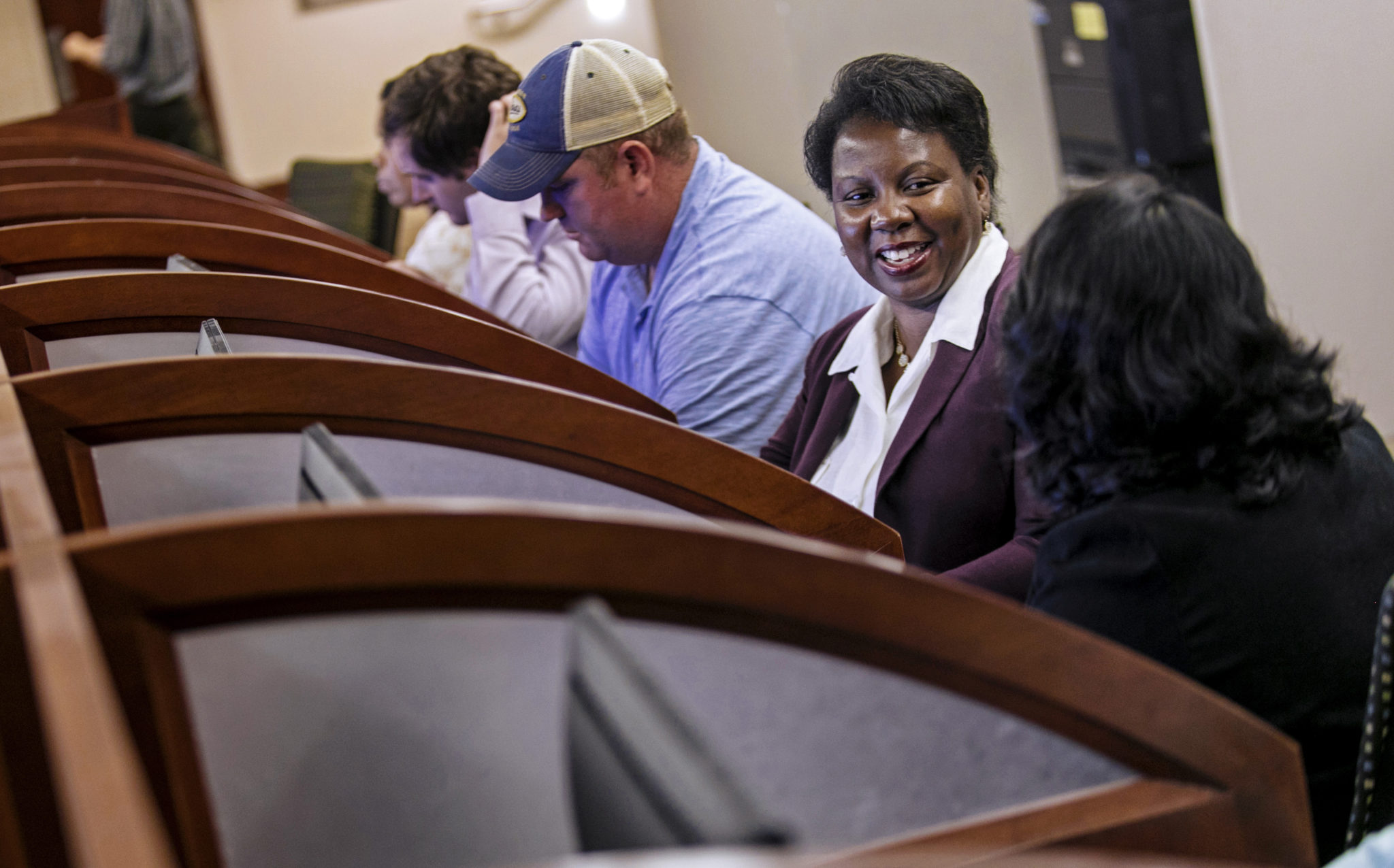 Students attending evening classes work in a library computer lab