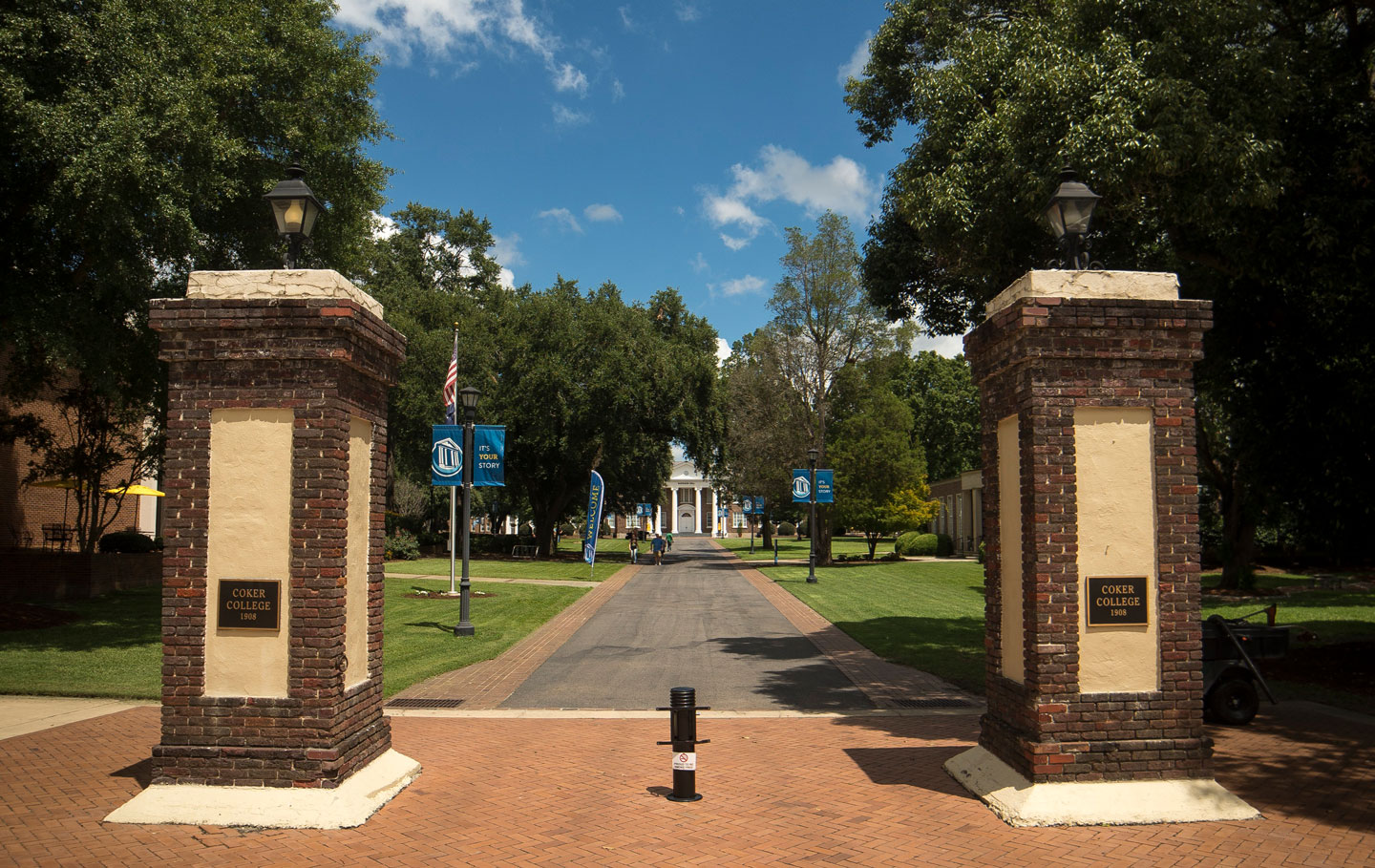 Historic brick gates of Coker's Campus with Davidson in the middle down a path