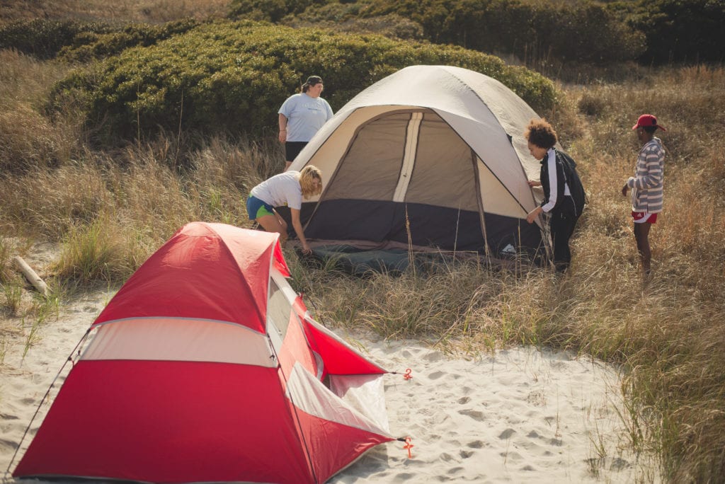 4 students pitching a tent