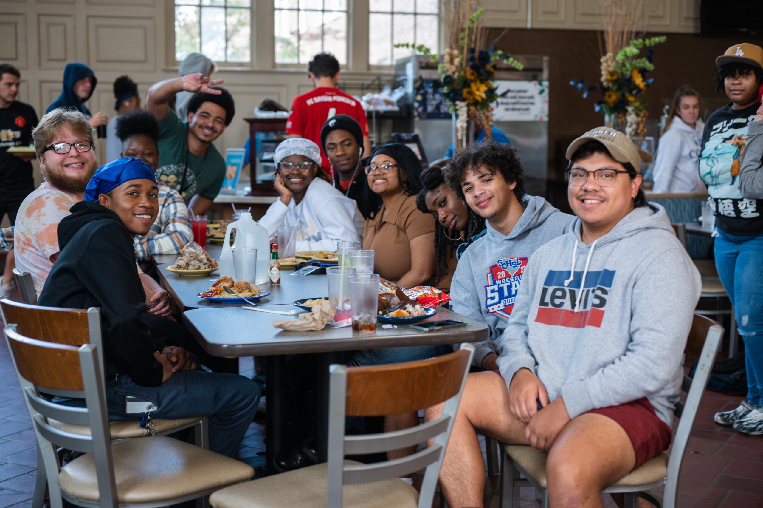 Happy Coker University students sitting in the dining hall.