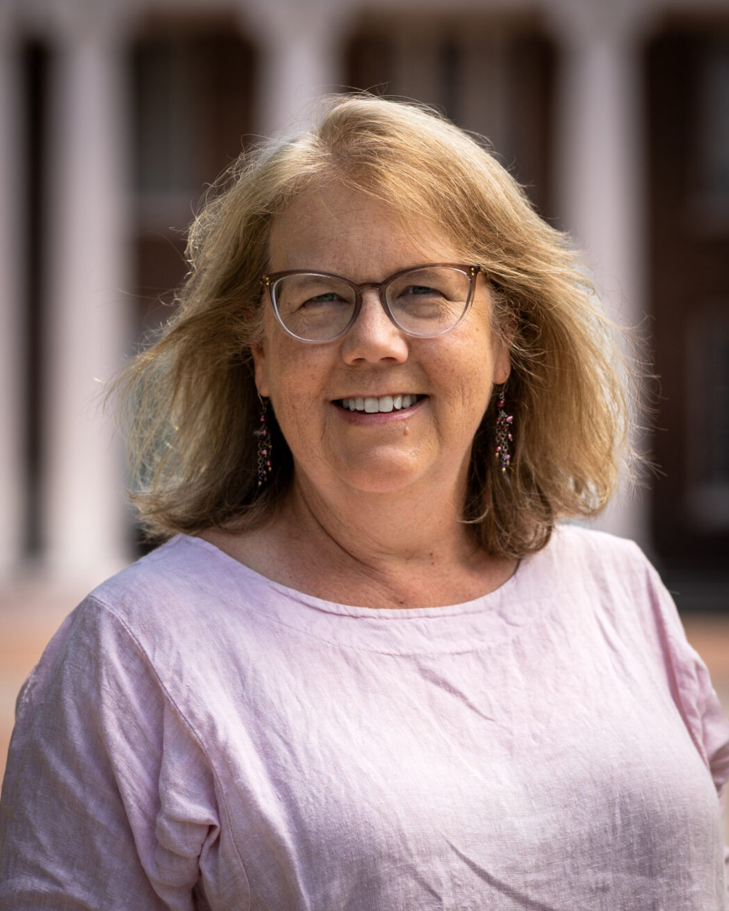 Dr. Margaret Godbey poses in front of Davidson Hall on Coker's campus.