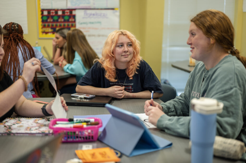 Students engage in discussion groups in class.